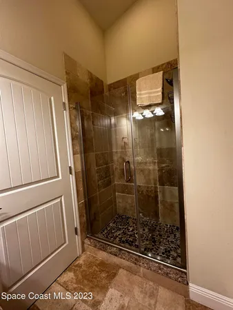 a bathroom with a glass shower door