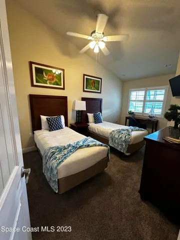 a bedroom with bed and a chandelier