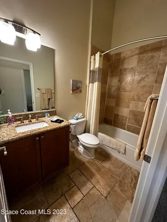 a bathroom with a double vanity sink toilet and shower