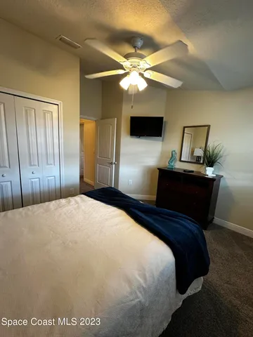 a bedroom with a bed and a chandelier