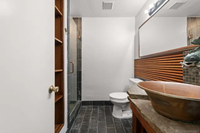 a bathroom with a toilet and a shower