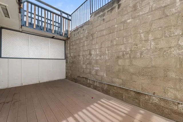 a view of a balcony with wooden floor