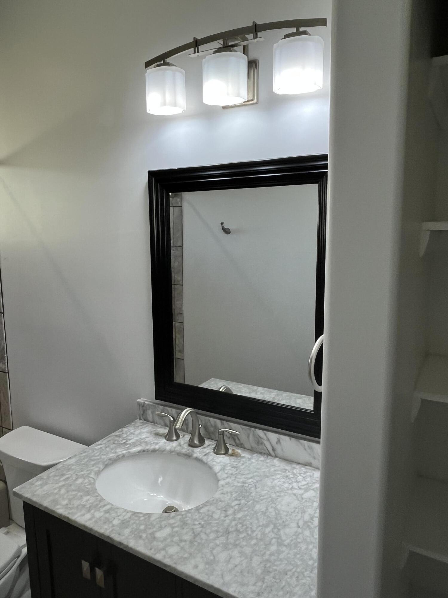 639 Cabrera Street Key Largo, FL 33037 - Photo 15 of 24 a bathroom with a granite countertop sink and a mirror
