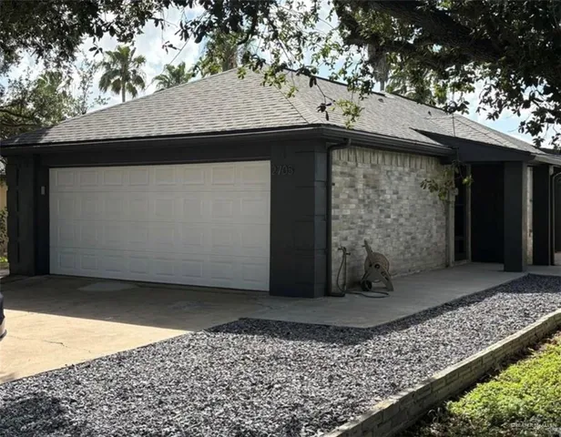 a view of a wooden house with a large tree