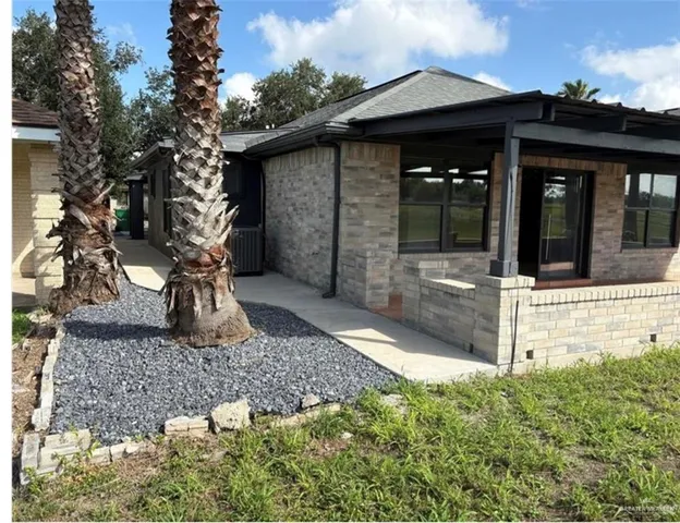 a view of house with tree in front of it