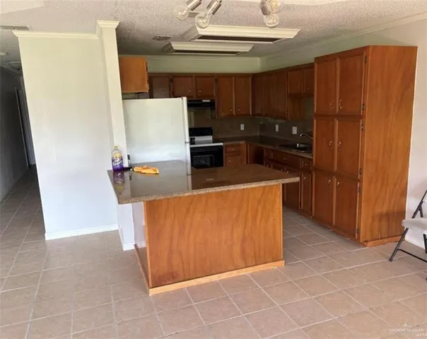 a kitchen with stainless steel appliances a refrigerator and a stove top oven