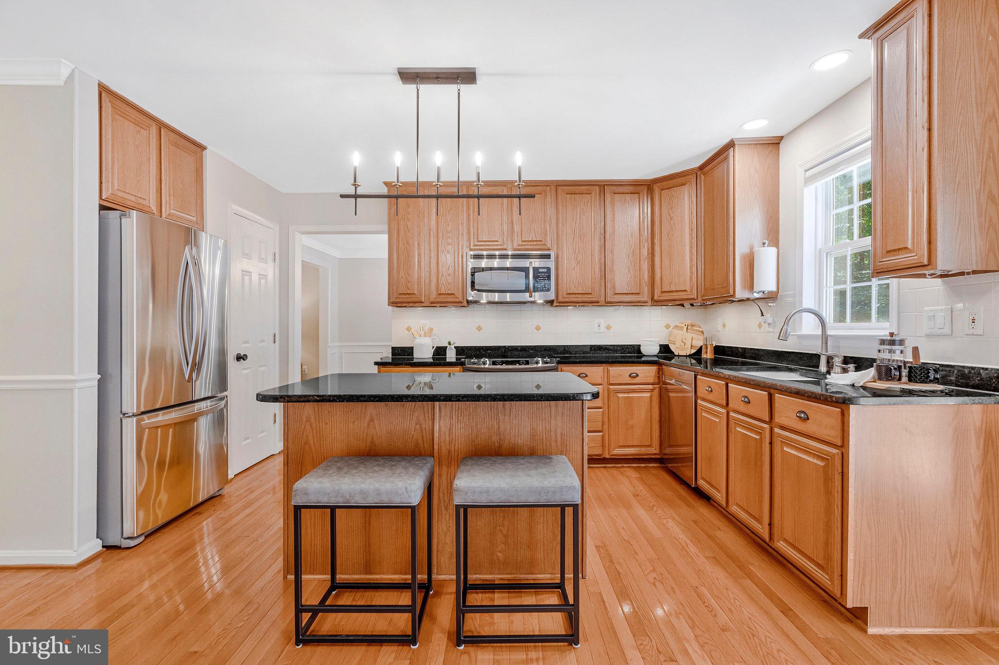6265 Happy Creek Road Manassas, VA 20112 - Photo 16 of 50 Modern kitchen with elegant wood cabinetry.