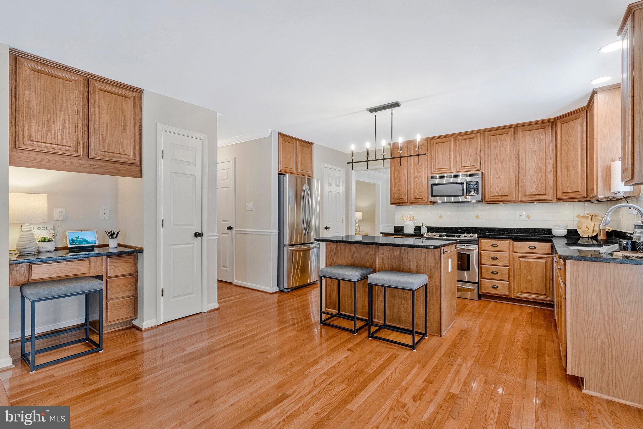 6265 Happy Creek Road Manassas, VA 20112 - Photo 17 of 50 Modern kitchen with warm wood accents.