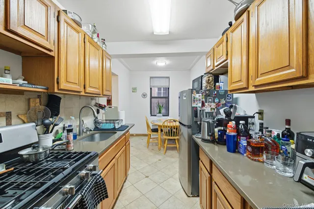 a kitchen filled with a white stove top oven and cabinets