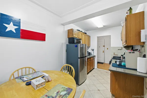 a view of a kitchen with fridge and workspace