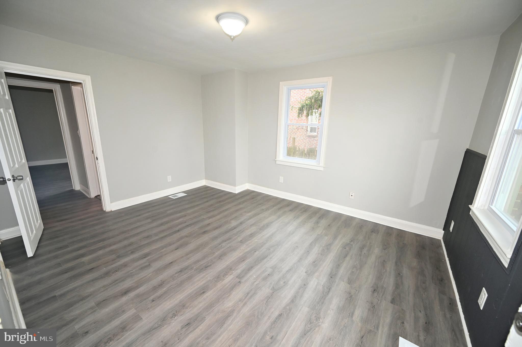 2952 Sollers Point Road, Unit B Dundalk, MD 21222 - Photo 10 of 37 an empty room with wooden floor and windows