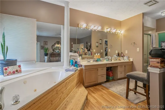 a large bathroom with a sink mirror and a bath tub