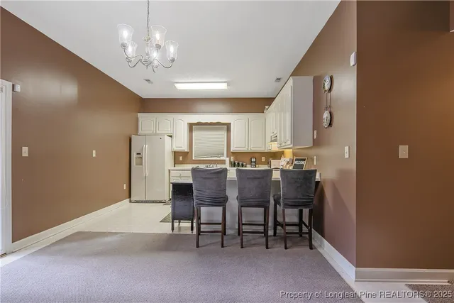 a view of a dining room with furniture and chandelier
