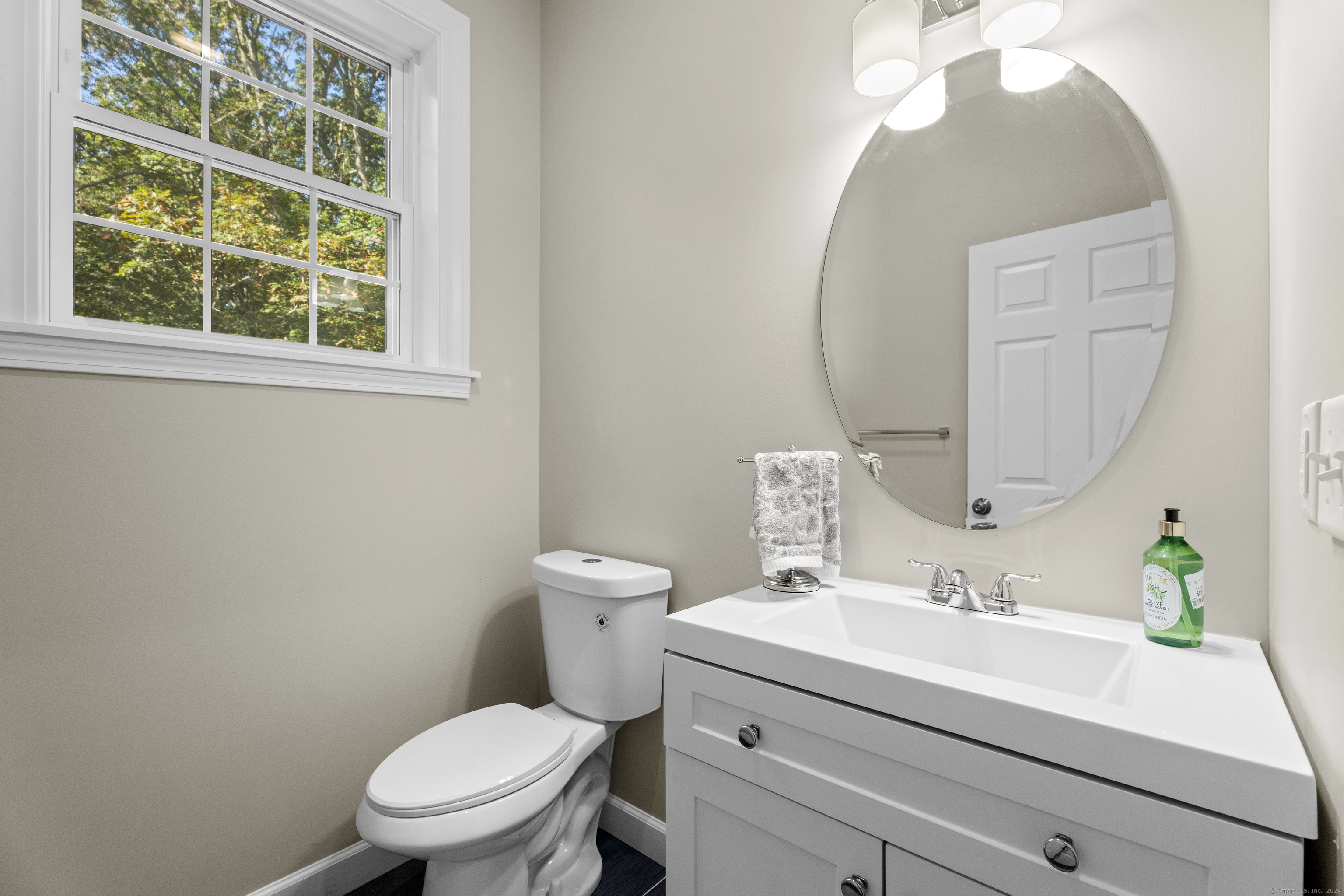 205 Winding Hollow Road Groton, CT 06340 - Photo 15 of 20 a bathroom with a sink a toilet and a mirror