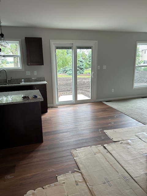 79.2 Periwinkle Court Morris, IL 60450 - Photo 3 of 12 an empty room with wooden floor and windows