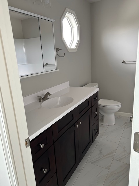79.2 Periwinkle Court Morris, IL 60450 - Photo 8 of 12 a bathroom with a sink vanity and a mirror
