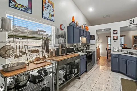 a large kitchen with stainless steel appliances granite countertop a stove and a sink