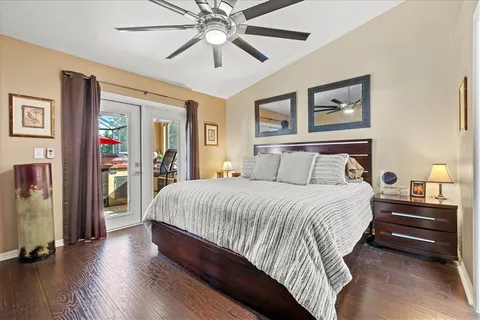 a bedroom with a large bed and a chandelier