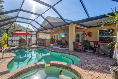 a view of a backyard patio with swimming pool table and chairs