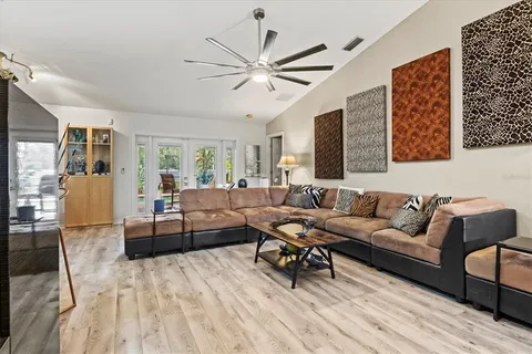 a living room with furniture and a wooden floor