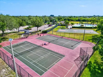 a view of a swimming pool with a patio and a garden