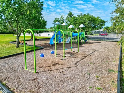 a view of a patio with dining table and chairs under an umbrella