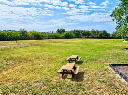 a view of buildings with yard and sitting area