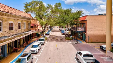 an outdoor space with wooden floor and city view