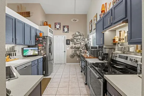 a kitchen with stainless steel appliances a stove a sink and a refrigerator