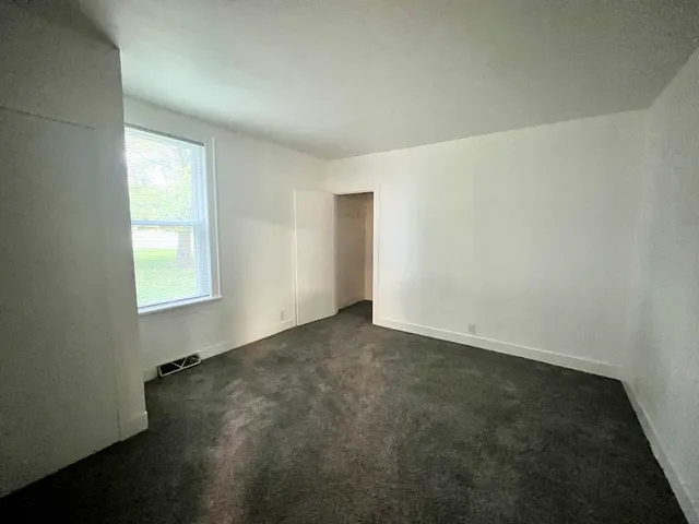 an empty room with a empty space and windows