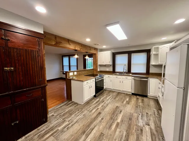 a kitchen with a refrigerator and a sink