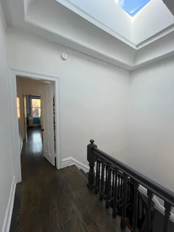 a view of hallway with wooden floor