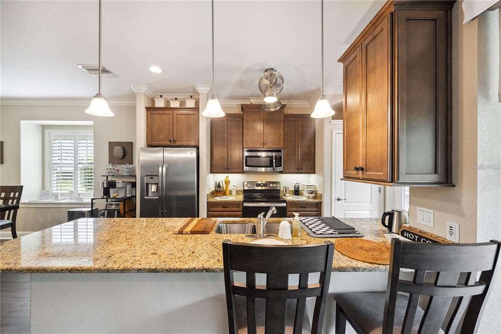 1923 Banning Beach Road Tavares, FL 32778 - Photo 12 of 44 a kitchen with granite countertop a table chairs stove and granite counter tops