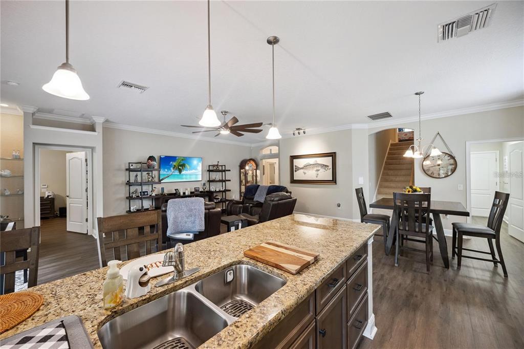1923 Banning Beach Road Tavares, FL 32778 - Photo 13 of 44 a view of a dining room and livingroom with furniture wooden floor a chandelier