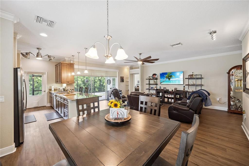 1923 Banning Beach Road Tavares, FL 32778 - Photo 17 of 44 a view of a dining room and livingroom with furniture wooden floor a chandelier