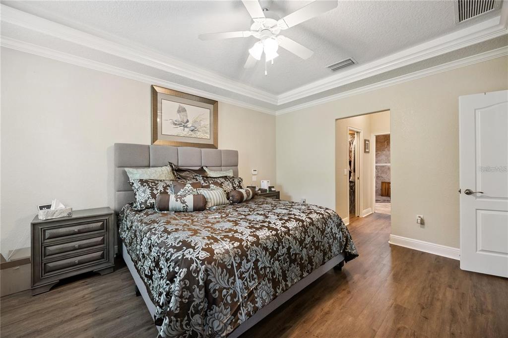 1923 Banning Beach Road Tavares, FL 32778 - Photo 20 of 44 a bedroom with a bed and a chandelier