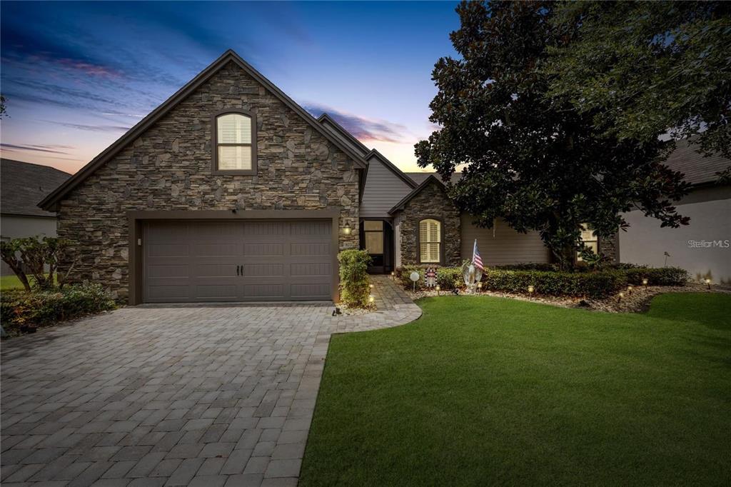 1923 Banning Beach Road Tavares, FL 32778 - Photo 2 of 44 a front view of a house with a yard and garage