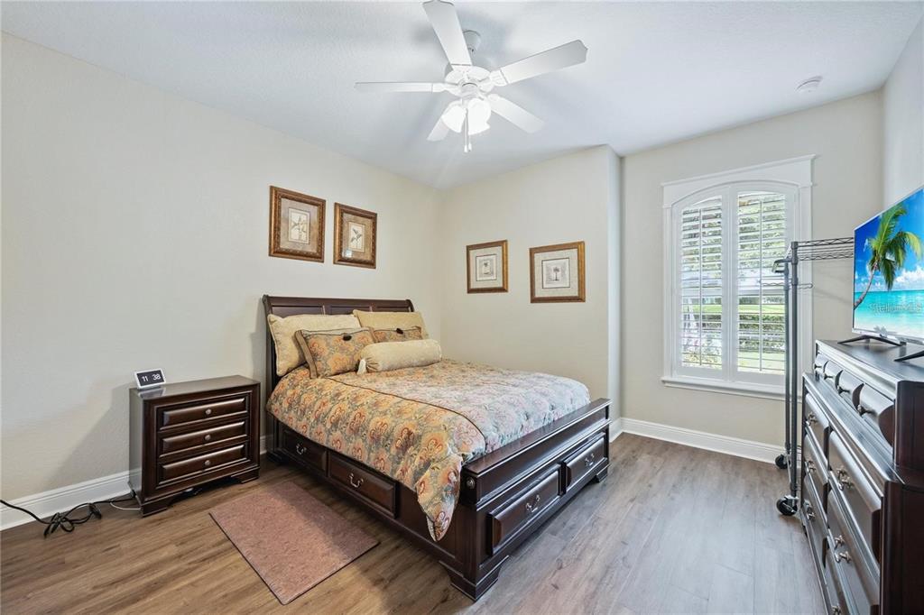 1923 Banning Beach Road Tavares, FL 32778 - Photo 26 of 44 a bedroom with a bed next to a window with a bookshelf