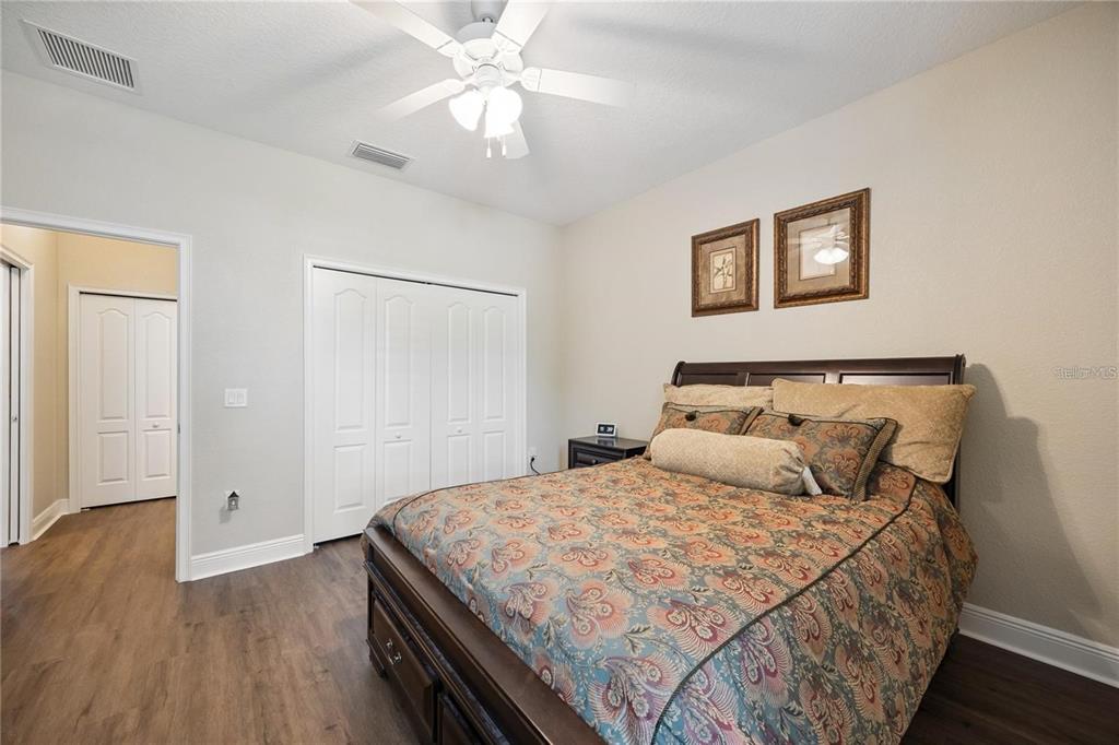 1923 Banning Beach Road Tavares, FL 32778 - Photo 27 of 44 a bedroom with a bed and wooden floor