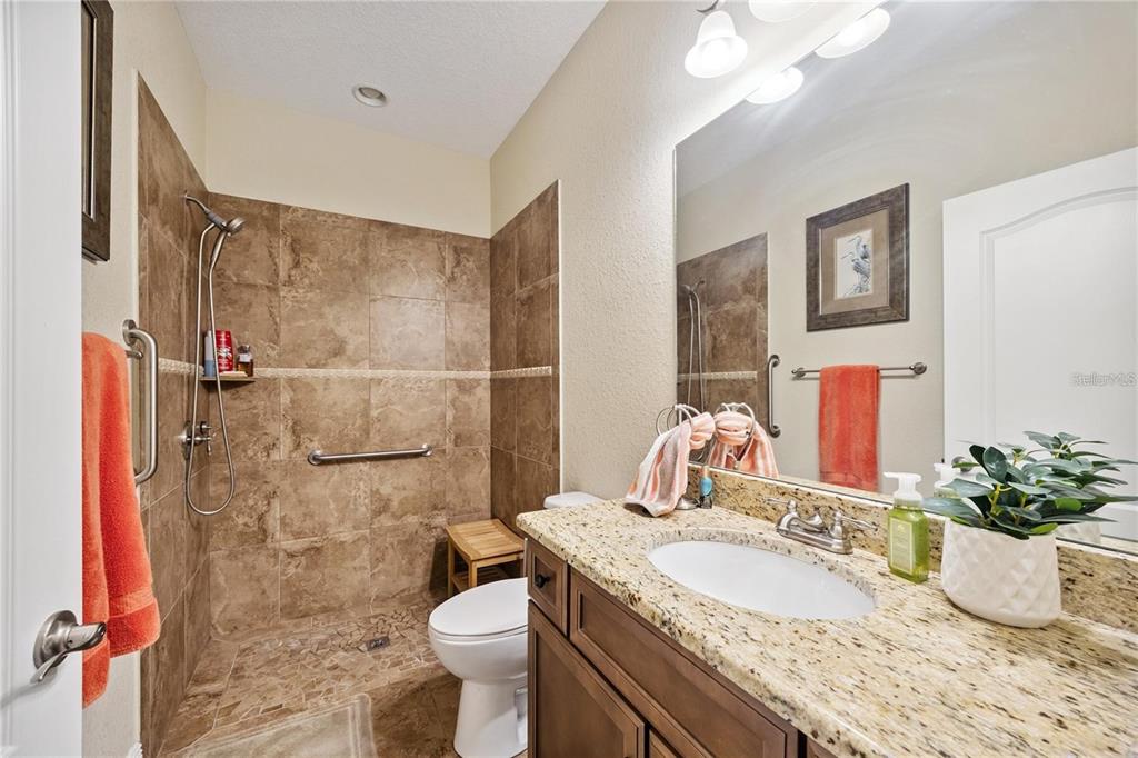 1923 Banning Beach Road Tavares, FL 32778 - Photo 28 of 44 a bathroom with a granite countertop sink and a mirror