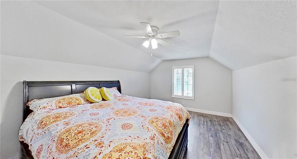 1923 Banning Beach Road Tavares, FL 32778 - Photo 29 of 44 a bedroom with a bed and wooden floor