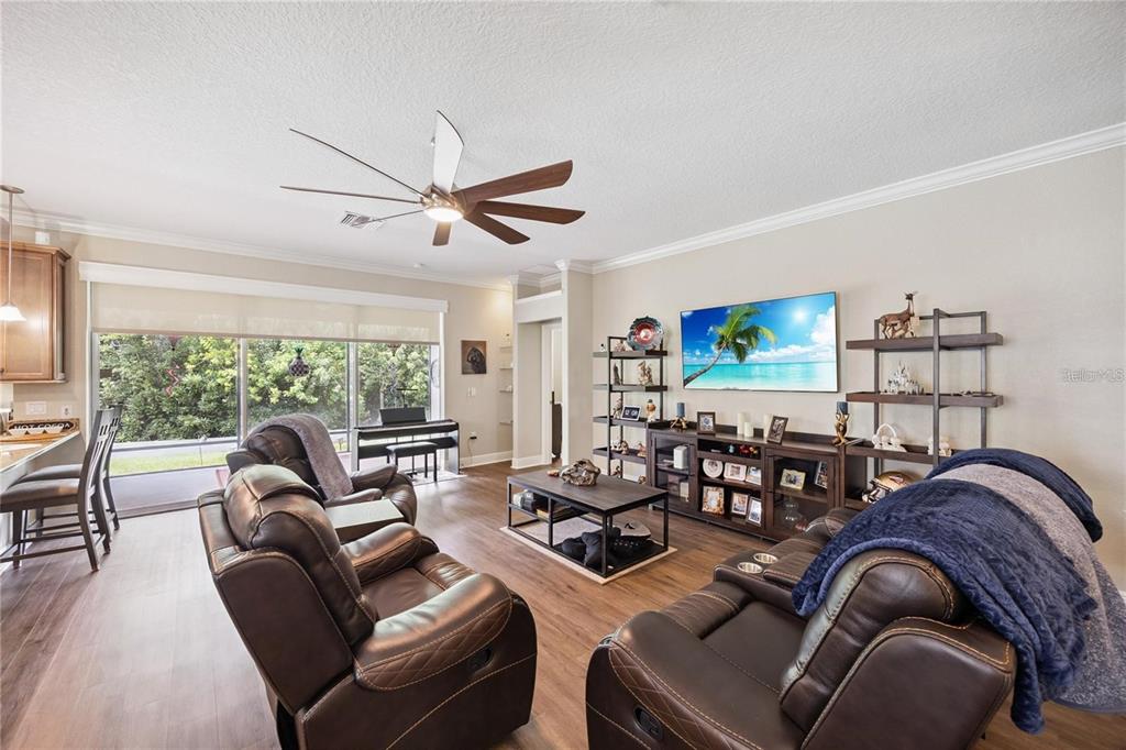 1923 Banning Beach Road Tavares, FL 32778 - Photo 3 of 44 a living room with furniture a large window and a flat screen tv