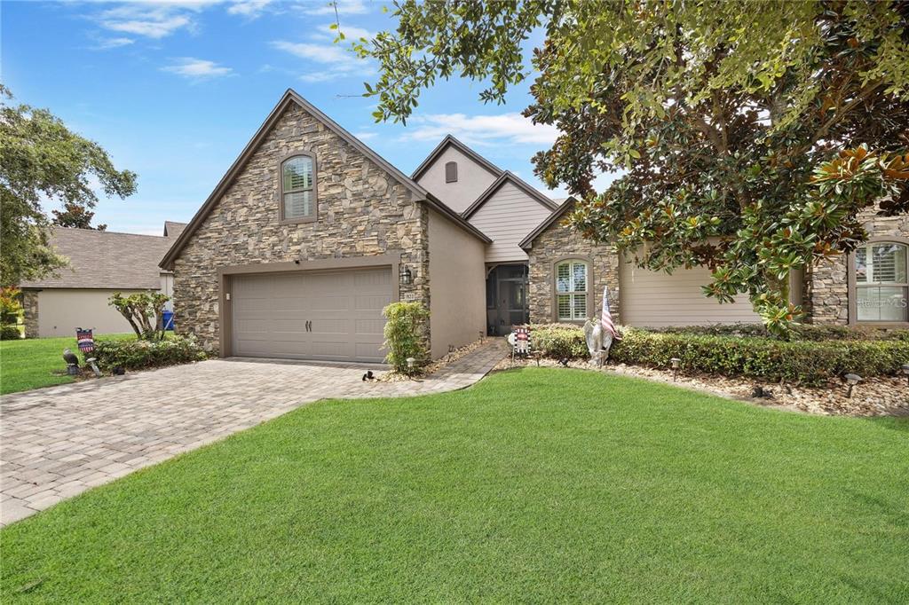 1923 Banning Beach Road Tavares, FL 32778 - Photo 41 of 44 a front view of a house with a yard and garage