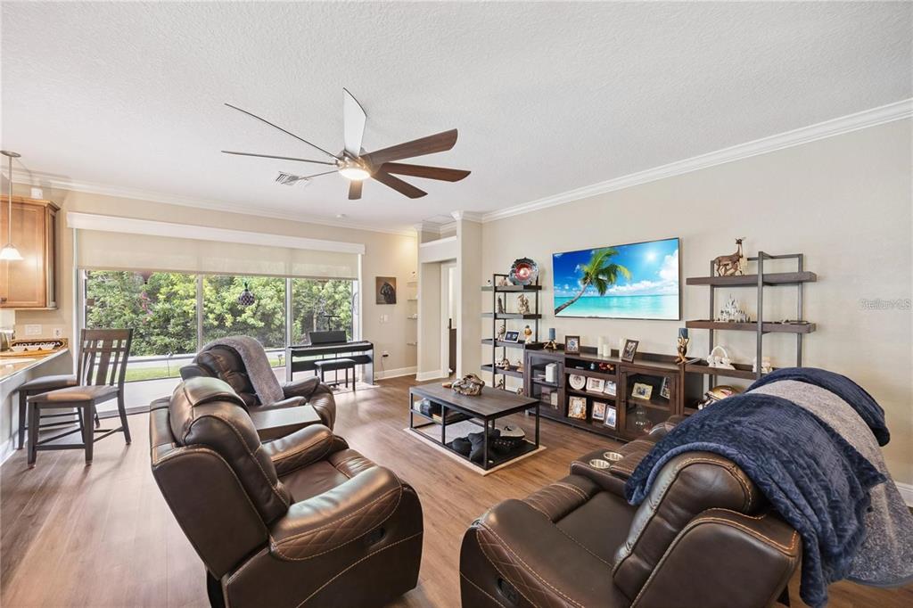 1923 Banning Beach Road Tavares, FL 32778 - Photo 7 of 44 a living room with furniture a large window and a flat screen tv
