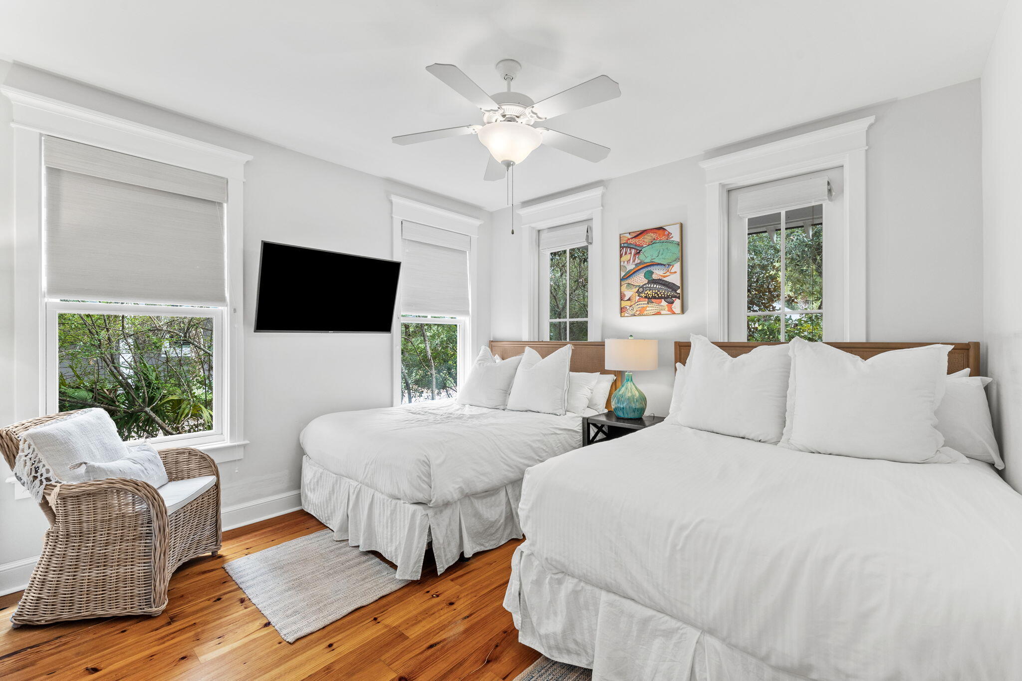 19 Creek Bridge Way Watersound, FL 32461 - Photo 15 of 35 a bedroom with two beds a flat screen tv and a large window