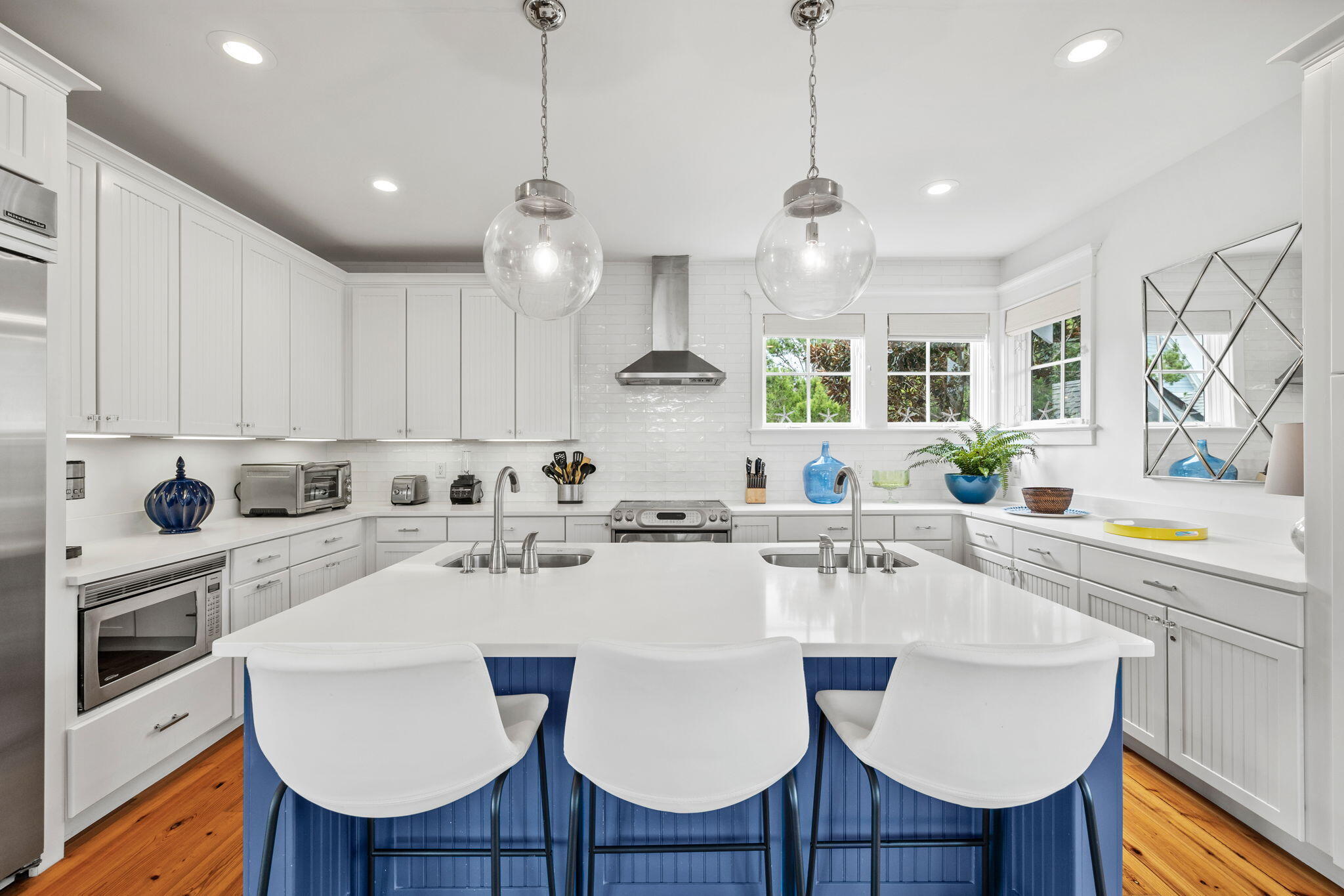 19 Creek Bridge Way Watersound, FL 32461 - Photo 20 of 35 a kitchen with stainless steel appliances kitchen island granite countertop a sink a stove a dining table and chairs