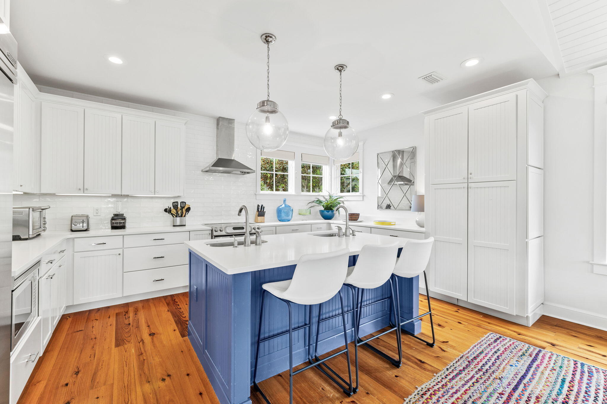 19 Creek Bridge Way Watersound, FL 32461 - Photo 2 of 35 a large kitchen with a sink and wooden floor