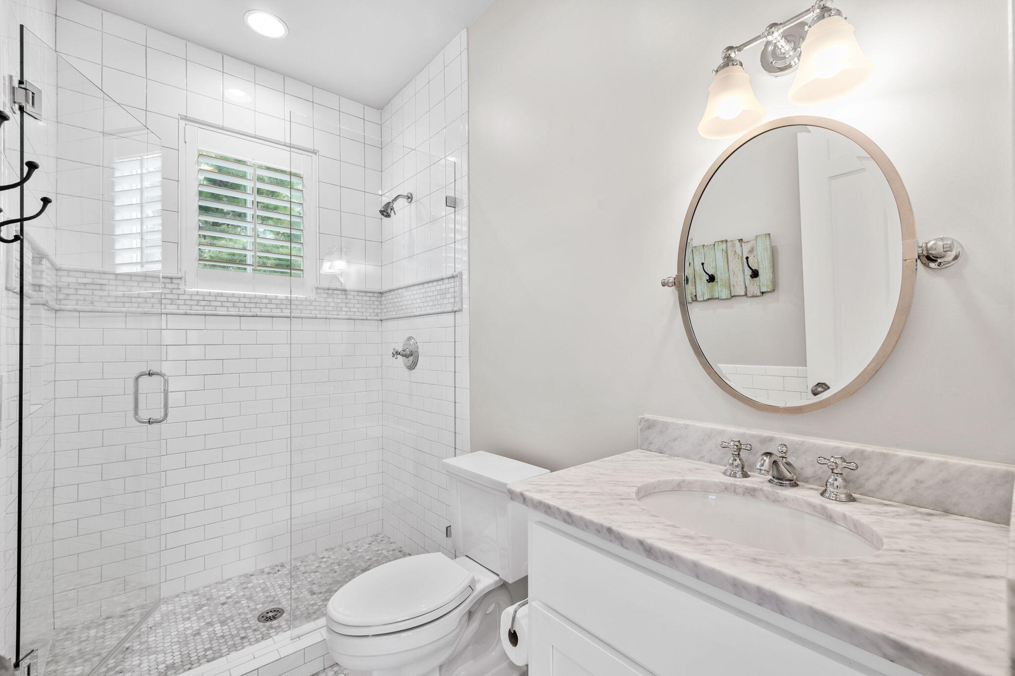 19 Creek Bridge Way Watersound, FL 32461 - Photo 29 of 35 a bathroom with a granite countertop toilet a sink and a mirror