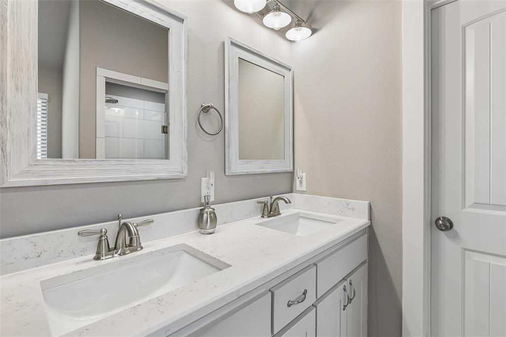 108 Maverick Lane Pilot Point, TX 76258 - Photo 20 of 27 Bathroom vanity featuring dual undermount sinks with brushed nickel fixtures