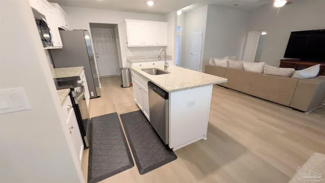 a bathroom with a sink a mirror and a washer dryer